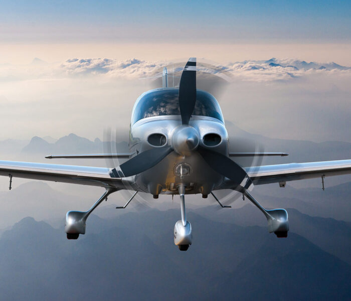Privatplaneoraircraftflightsurroundedbymountainsandrocks.Frontviewcloseup2